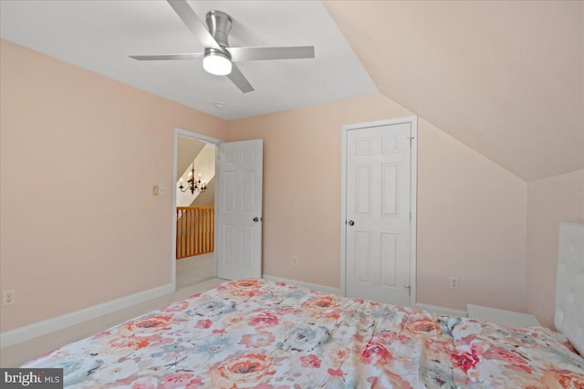 bedroom featuring ceiling fan, carpet floors, and lofted ceiling