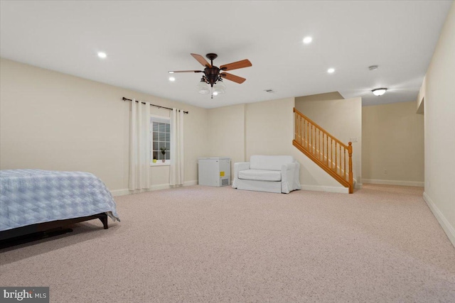 bedroom with ceiling fan and light carpet