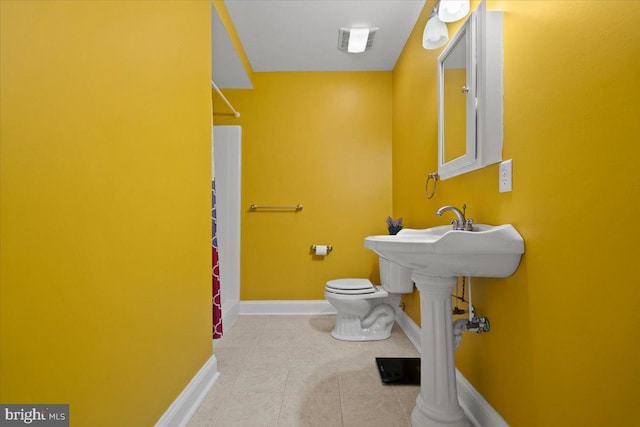 bathroom featuring tile patterned flooring and toilet