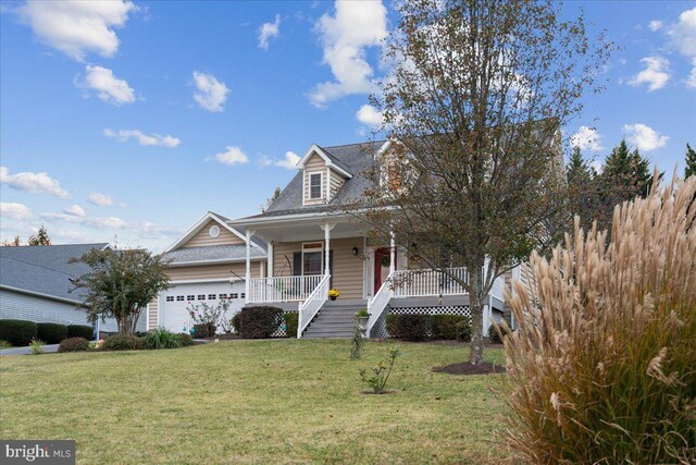 view of front of property with a garage, covered porch, and a front lawn