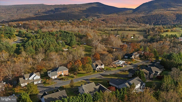 aerial view at dusk featuring a mountain view