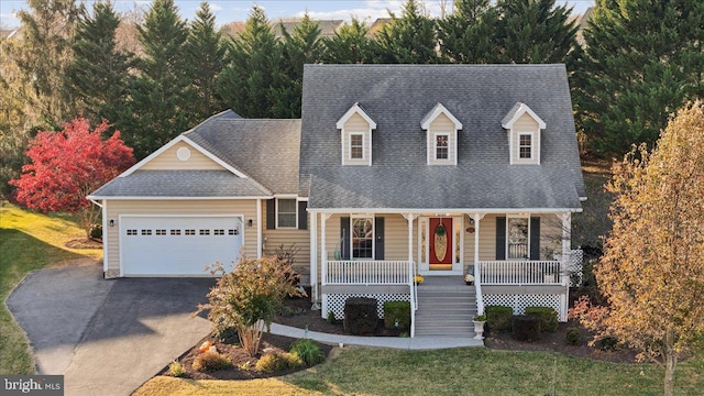 cape cod-style house with covered porch, a garage, and a front yard