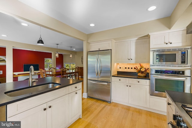 6503 Fleecydale Rd, New Hope, PA 18938 - kitchen with dark countertops, backsplash, appliances with stainless steel finishes, and a sink