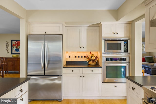 6503 Fleecydale Rd, New Hope, PA 18938 - kitchen with backsplash, dark countertops, stainless steel appliances, and light wood-type flooring