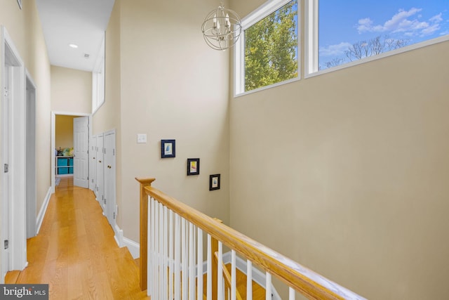 6503 Fleecydale Rd, New Hope, PA 18938 - hallway with an upstairs landing, light wood-style floors, an inviting chandelier, baseboards, and recessed lighting