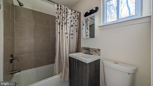 full bathroom with vanity, shower / bath combo, and toilet