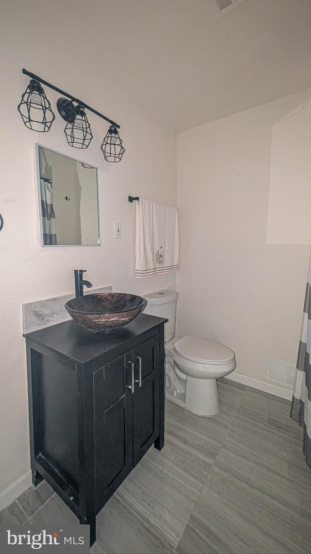 bathroom featuring vanity and toilet