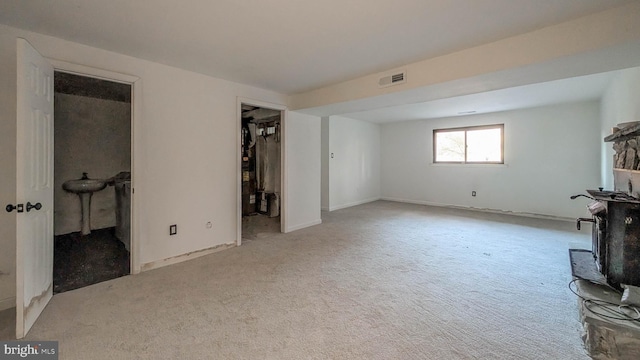 unfurnished living room featuring light carpet