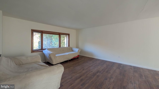 unfurnished living room with dark hardwood / wood-style floors