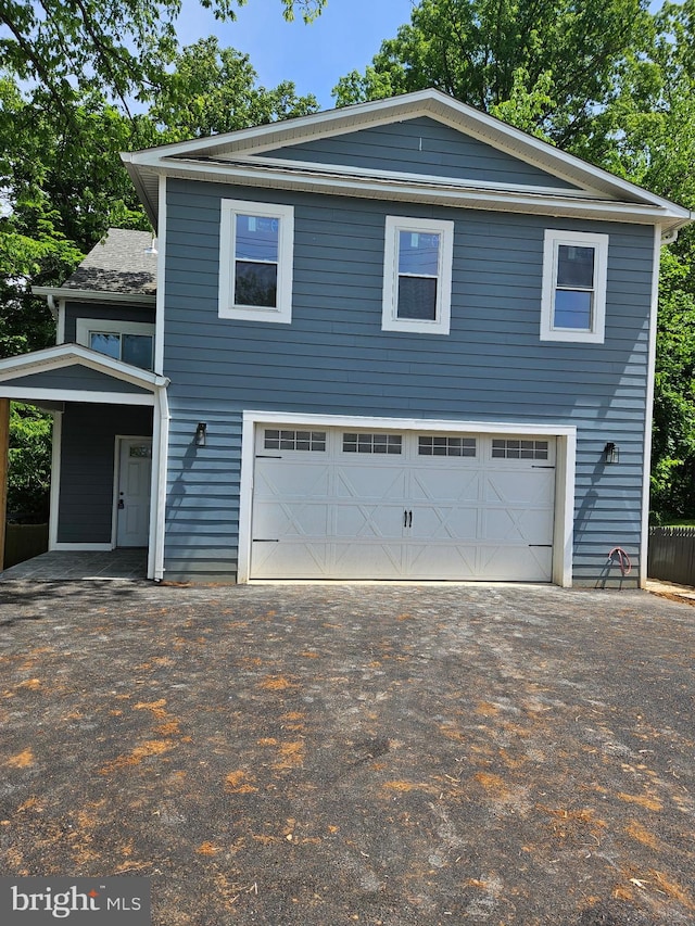 view of front facade featuring asphalt driveway
