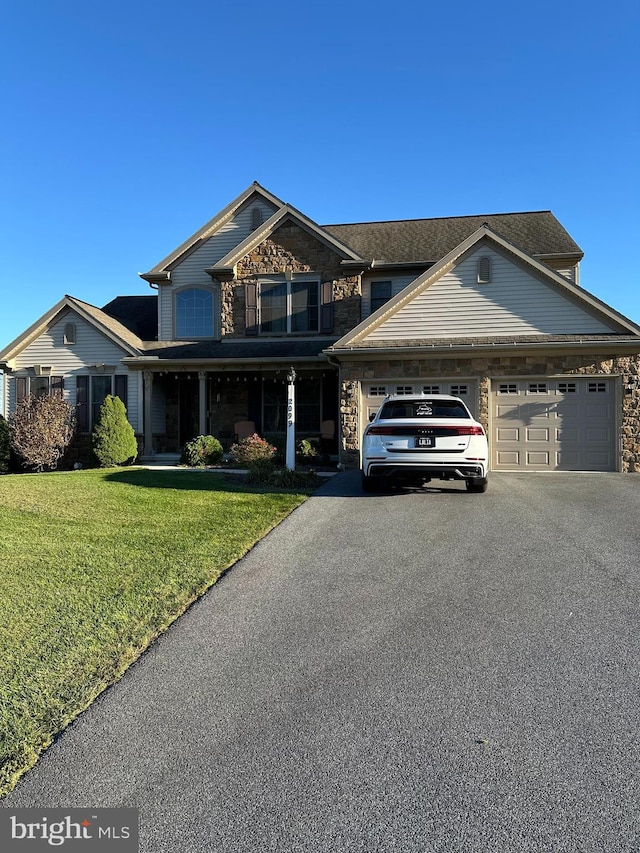 view of front of property featuring a front yard and a garage