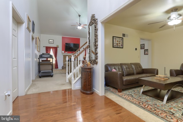 living room with light hardwood / wood-style floors and ceiling fan