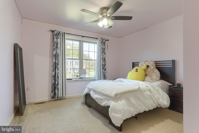 bedroom featuring light colored carpet and ceiling fan