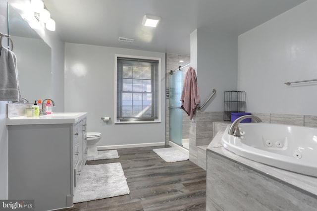 full bathroom with vanity, toilet, hardwood / wood-style flooring, and shower with separate bathtub