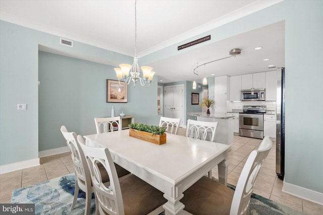 tiled dining space with a chandelier