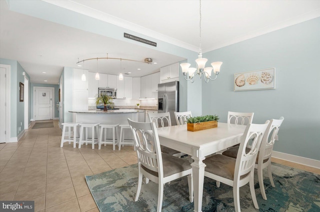 tiled dining area with ornamental molding and a notable chandelier