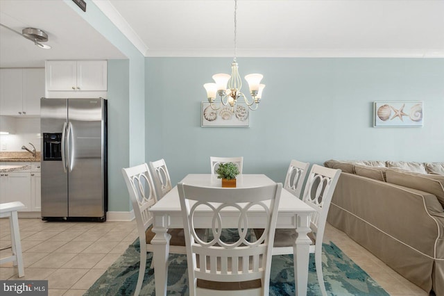 tiled dining space featuring a chandelier and crown molding