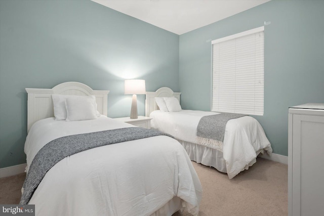 bedroom featuring light carpet