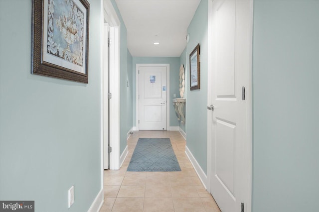 corridor featuring light tile patterned floors