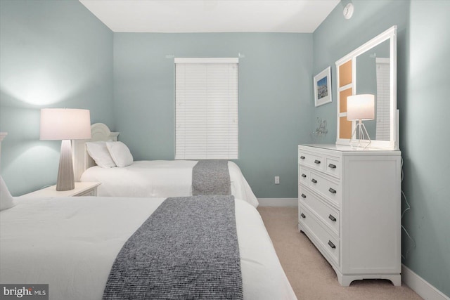 bedroom featuring light carpet