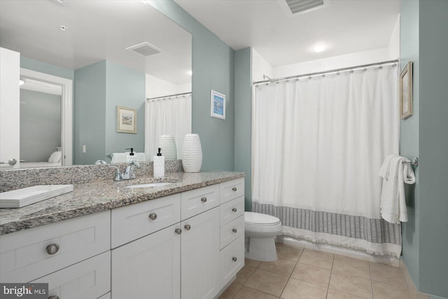 bathroom with vanity, a shower with curtain, toilet, and tile patterned flooring