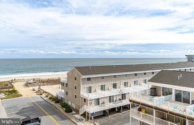 aerial view featuring a water view and a beach view