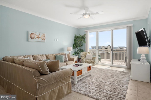 tiled living room with ornamental molding and ceiling fan