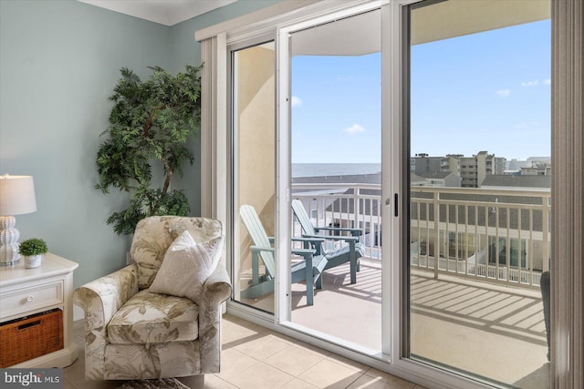 sitting room featuring light tile patterned flooring and a water view