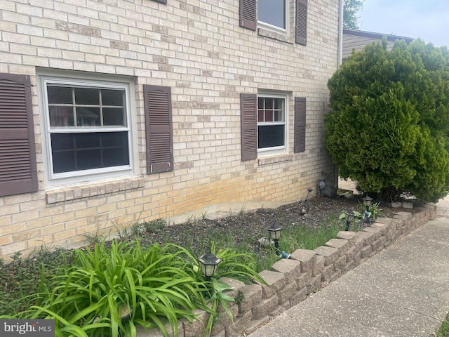 view of side of home with brick siding