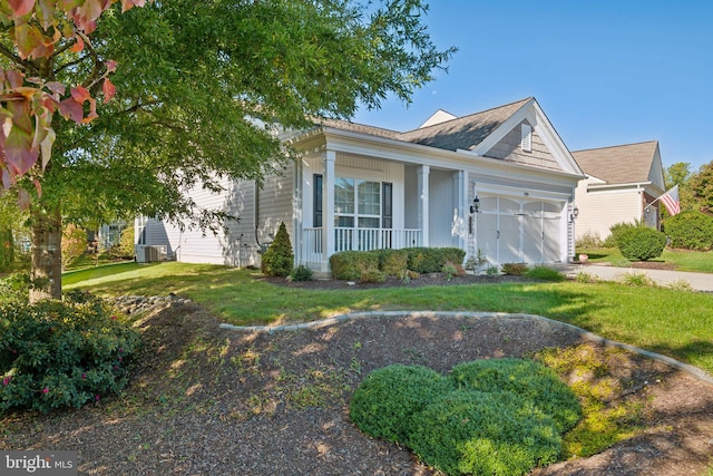 view of front facade with covered porch, a garage, and a front yard