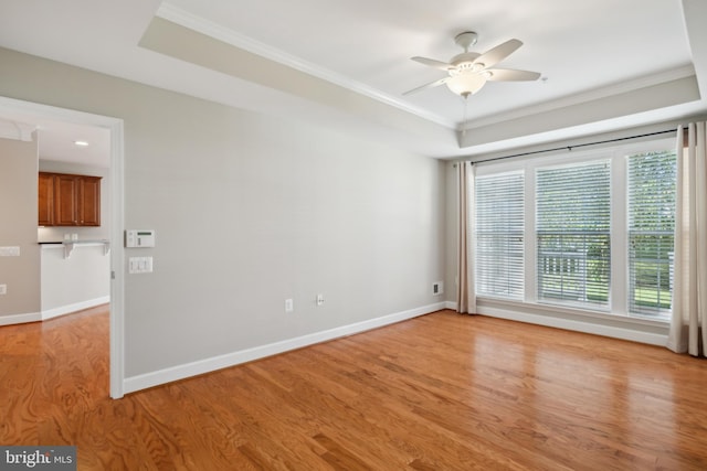 spare room featuring ceiling fan, ornamental molding, and light hardwood / wood-style flooring