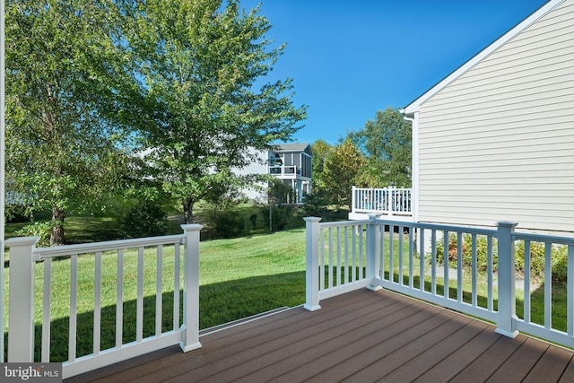 wooden terrace with a yard