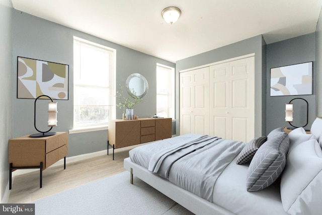 bedroom featuring light hardwood / wood-style flooring and a closet