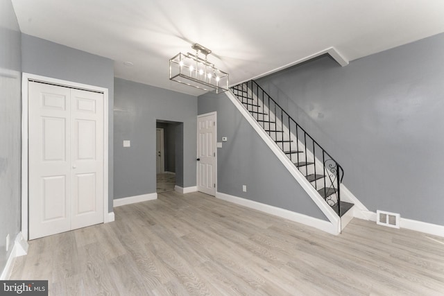 interior space featuring a chandelier and wood-type flooring