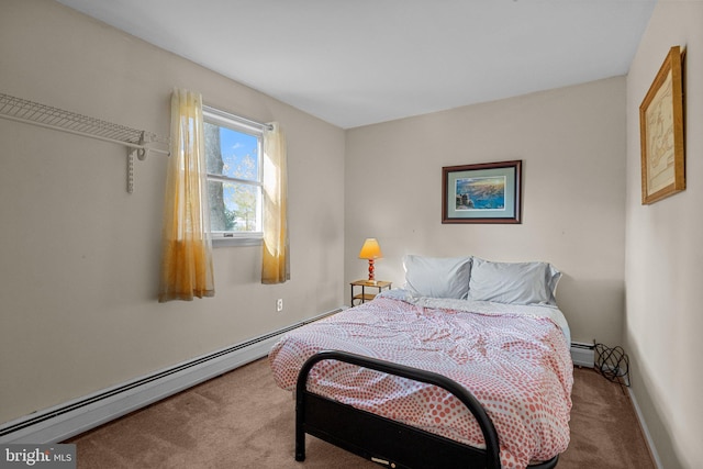 bedroom with a baseboard heating unit and carpet