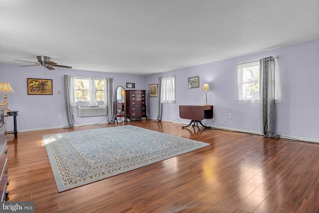 living room with light hardwood / wood-style floors, ceiling fan, and plenty of natural light