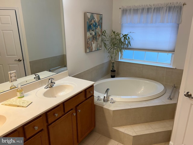 bathroom with vanity, tile patterned floors, and tiled bath