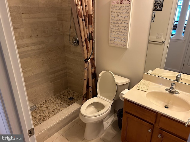 bathroom featuring vanity, tile patterned floors, toilet, and walk in shower