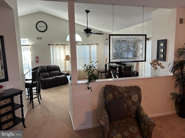 living room with ceiling fan, lofted ceiling, and carpet floors