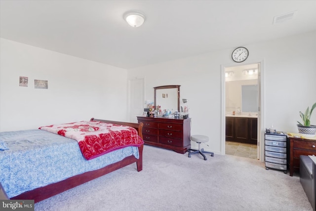 carpeted bedroom with ensuite bathroom