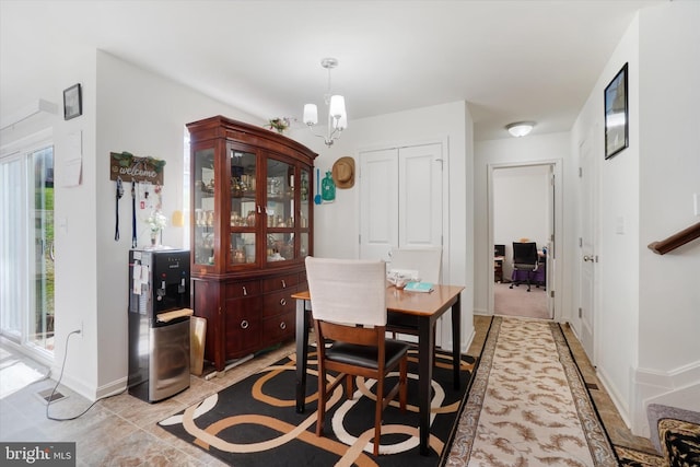 dining space with an inviting chandelier