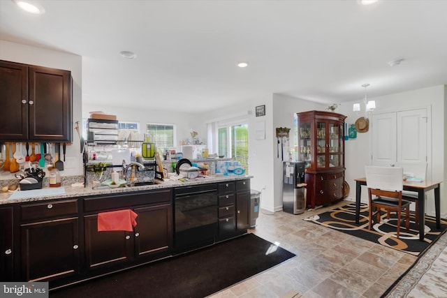 kitchen with dishwasher, sink, dark brown cabinets, and light stone counters