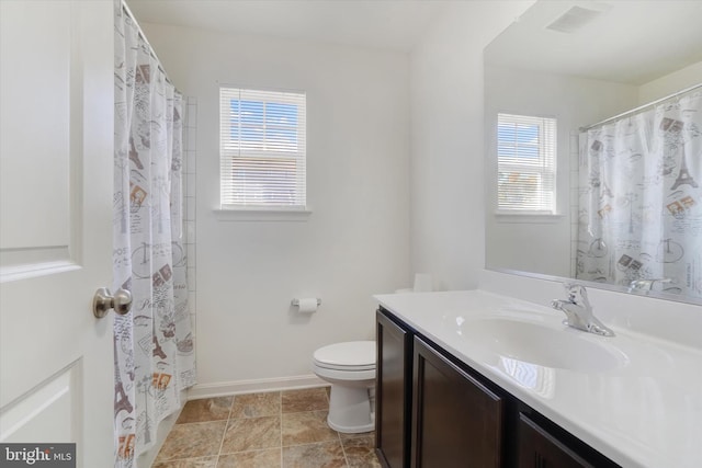 bathroom with vanity, toilet, and curtained shower