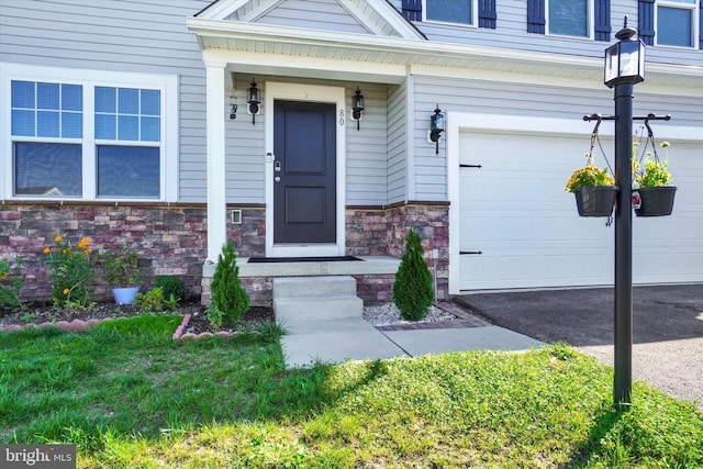 doorway to property with a garage