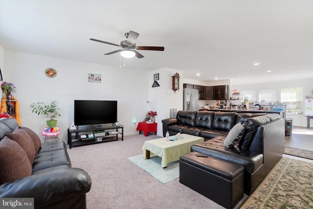 carpeted living room featuring ceiling fan