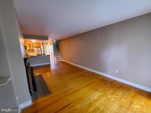 unfurnished living room featuring hardwood / wood-style flooring