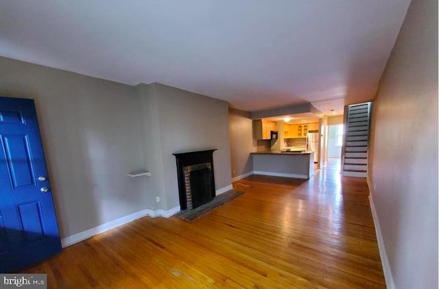 unfurnished living room with light wood-type flooring