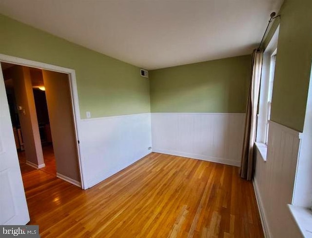 spare room with hardwood / wood-style floors