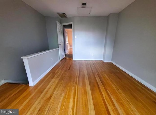 empty room with light hardwood / wood-style flooring