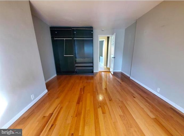 unfurnished room with hardwood / wood-style flooring